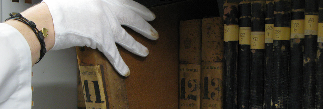 Frequently Asked Questions photo of person's hand pulling a book off shelf